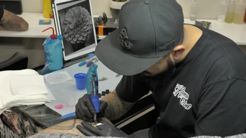 Stock Video Bearded Tattooist Making A Flower Live Wallpaper For PC - Live Wallpaper