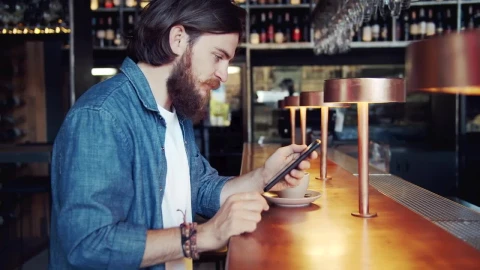 Stock Video Bearded Man Uses Mobile App In Urban Bar Live Wallpaper For PC - Live Wallpaper