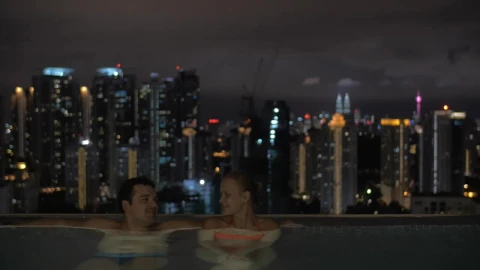 Stock Video Couple Talking In An Infinity Pool Live Wallpaper For PC - Stock Video Ice Cubes Thawing On Black Background Animated Wallpaper Wallpaper