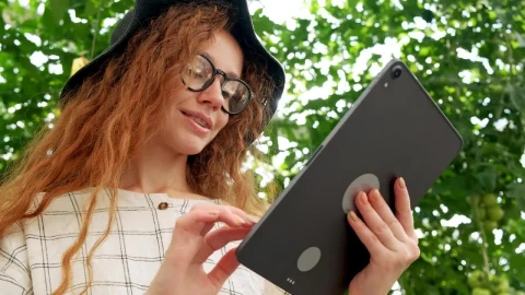 Stock Video Girl Using A Big Tablet In A Garden Live Wallpaper For PC - Live Wallpaper