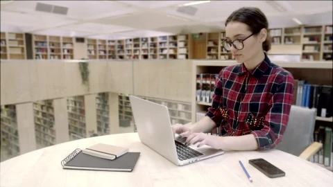 Stock Video Girl Typing On Laptop Computer In The Library Live Wallpaper For PC - Live Wallpaper