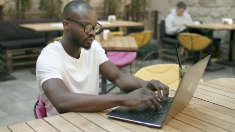 Stock Video Man Doing Online Research In Outdoor Cafe Animated Wallpaper - Live desktop wallpaper Wallpaper