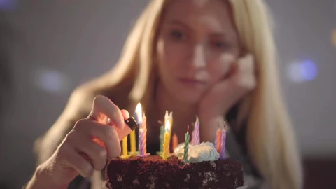 Stock Video Lonely Woman Lighting Candles On Her Birthday Cake Animated Wallpaper animated wallpaper preview