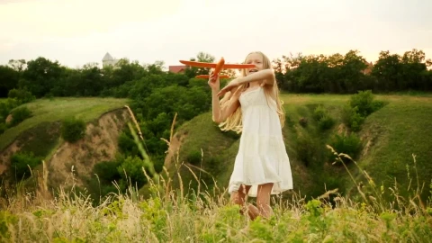 Stock Video Little Girl Throwing A Toy Plane In The Hills Animated Wallpaper - In Wallpaper