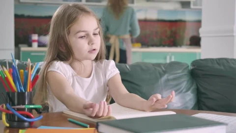 Stock Video Little Girl Studying Mathematics In Her Living Room Animated Wallpaper - In Wallpaper