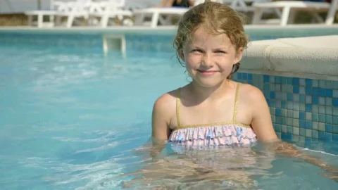 Stock Video Little Girl Sitting In Pool And Smiling Animated Wallpaper - In Wallpaper