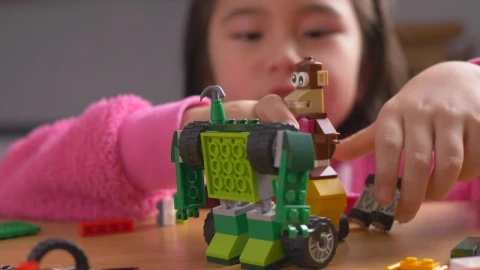 Stock Video Little Girl Playing With Lego Toys Animated Wallpaper animated wallpaper preview