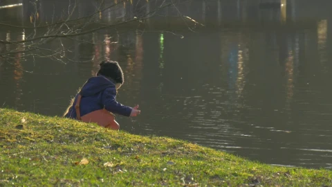 Stock Video Little Girl Playing In The Lakeshore Animated Wallpaper - In Wallpaper
