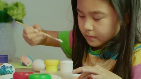 Stock Video Little Girl Painting Easter Eggs 4285 Animated Wallpaper animated wallpaper preview