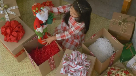 Stock Video Little Girl Opening Gifts At Christmas Animated Wallpaper animated wallpaper preview