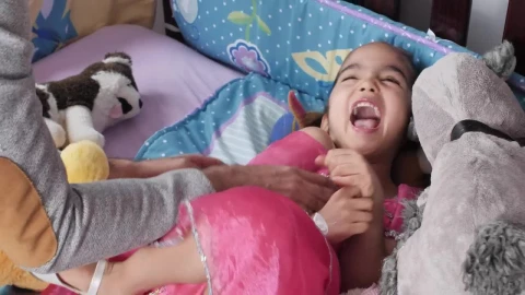 Stock Video Little Girl Lying Down While Her Father Tickles Her Animated Wallpaper animated wallpaper preview