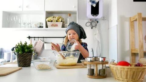 Stock Video Little Girl In The Kitchen Preparing Cookies Animated Wallpaper - In Wallpaper