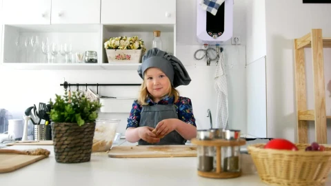 Stock Video Little Girl In A Kitchen Preparing Cookies Animated Wallpaper animated wallpaper preview