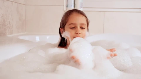 Stock Video Little Girl Covered In Foam In The Tub Animated Wallpaper - In Wallpaper