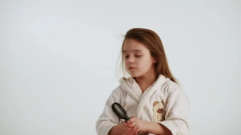 Stock Video Little Girl Combing Her Hair After Shower Animated Wallpaper animated wallpaper preview