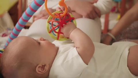 Stock Video Little Baby Playing With Toys In Bed Animated Wallpaper - In Wallpaper