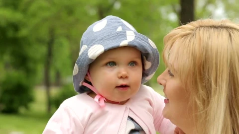Stock Video Little Baby In His Mothers Arms Looking Around Animated Wallpaper - In Wallpaper