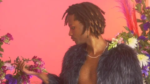 Stock Video Lgbtq Man Among Flowers While Appreciating Them Animated Wallpaper animated wallpaper preview
