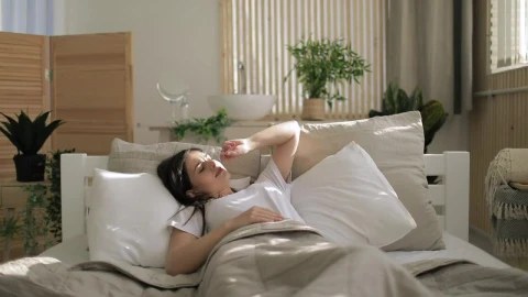 Stock Video Lazy Girl Wakes Up And Stays In Bed Smiling Animated Wallpaper - In Wallpaper