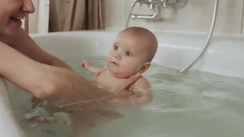 Stock Video Mother Playing With Her Baby In A Tub Of Wate Animated Wallpaper - In Wallpaper