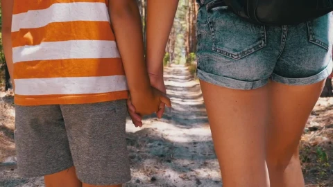 Stock Video Mother And Son Walk Hand In Hand In A Par Animated Wallpaper - In Wallpaper