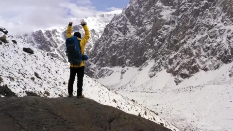 Stock Video Mountaineer Celebrating With Raised Arms In The Mountains Live Wallpaper - Live Wallpaper