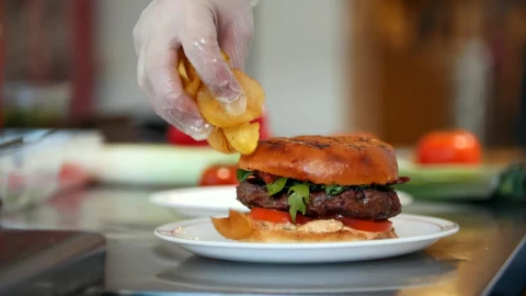 Video Stock Placing French Fries On A Plate With A Hamburger Live Wallpaper Free - A Wallpaper