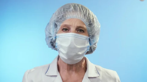 Video Stock Portrait Of An Adult Female Doctor On Blue Live Wallpaper Free animated wallpaper preview