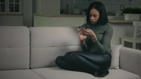Free Stock Video Young Woman Watching Her Phone In The Couch Live Wallpaper - Stock Wallpaper