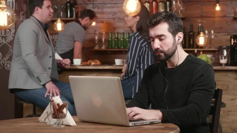 Stock Footage Urban Man Typing On Laptop Is Served Coffee In Hip Live Wallpaper animated wallpaper preview