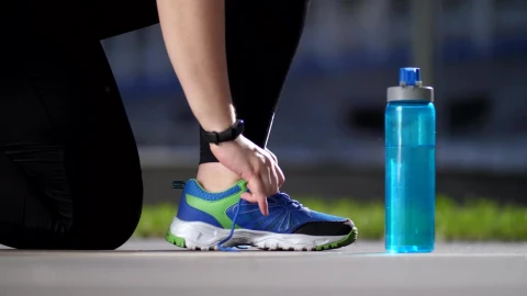 Stock Footage Typing Her Shoes Before Exercising Live Wallpaper animated wallpaper preview