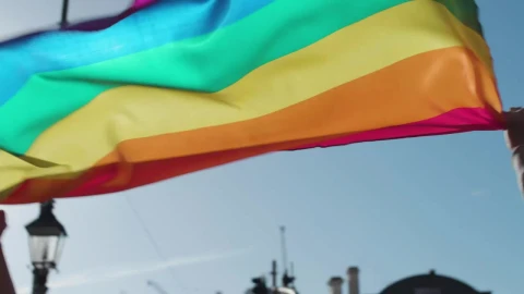 Stock Footage Two Men Holding Up A Rainbow Flag Live Wallpaper animated wallpaper preview