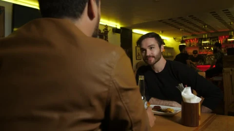 Stock Footage Two Men Chatting In A Restaurant Bar Live Wallpaper animated wallpaper preview