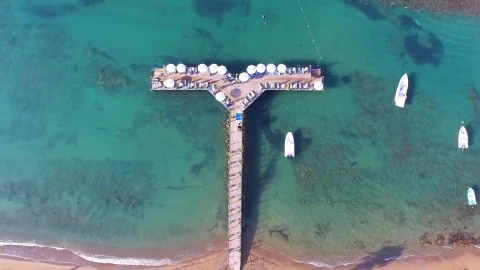 Stock Footage Tropical Pier With Umbrellas And Boats Live Wallpaper animated wallpaper preview