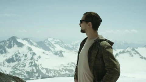 Stock Footage Young Man Standing On A Snow Covered Hill Live Wallpaper Free animated wallpaper preview