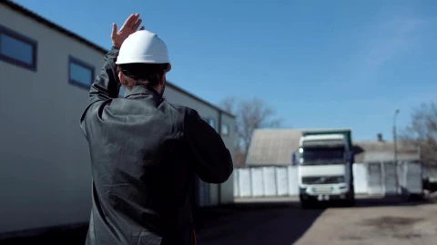 Stock Footage Worker Leading A Freight Truck In The Parking Live Wallpaper Free - Wallpaper Wallpaper