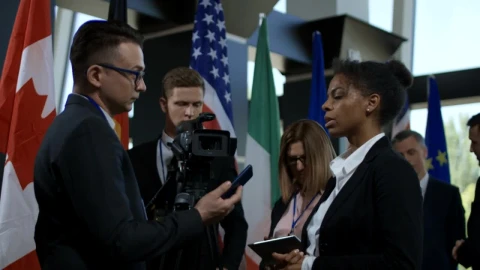 Stock Footage Woman Gives An Interview At An International Summit Live Wallpaper Free - Wallpaper Wallpaper