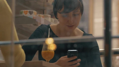 Stock Footage Woman Smiling As She Checks Her Phone Live Wallpaper Free - Wallpaper Wallpaper