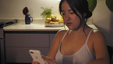 Stock Footage Woman Sitting In The Kitchen While Texting Live Wallpaper Free - Wallpaper Wallpaper