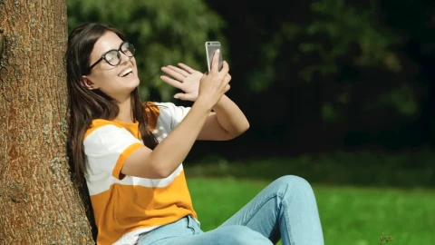 Stock Footage Woman Having A Video Call At The Park Live Wallpaper Free - Wallpaper Wallpaper