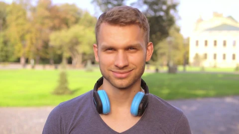 Stock Footage Young Man In A Garden Smiles From The Front Live Wallpaper Free - Live Wallpaper