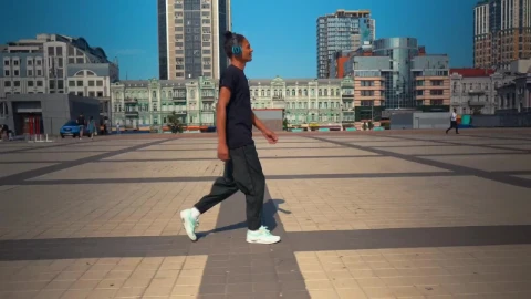 Stock Footage Young Man Walking Listening To Music From His Headphones Live Wallpaper Free - Live Wallpaper