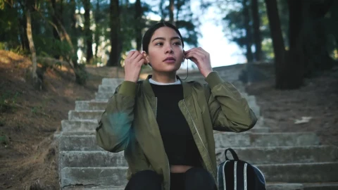 Stock Footage Woman Wearing Active Wear Puts On Headphones Live Wallpaper Free - Live Wallpaper