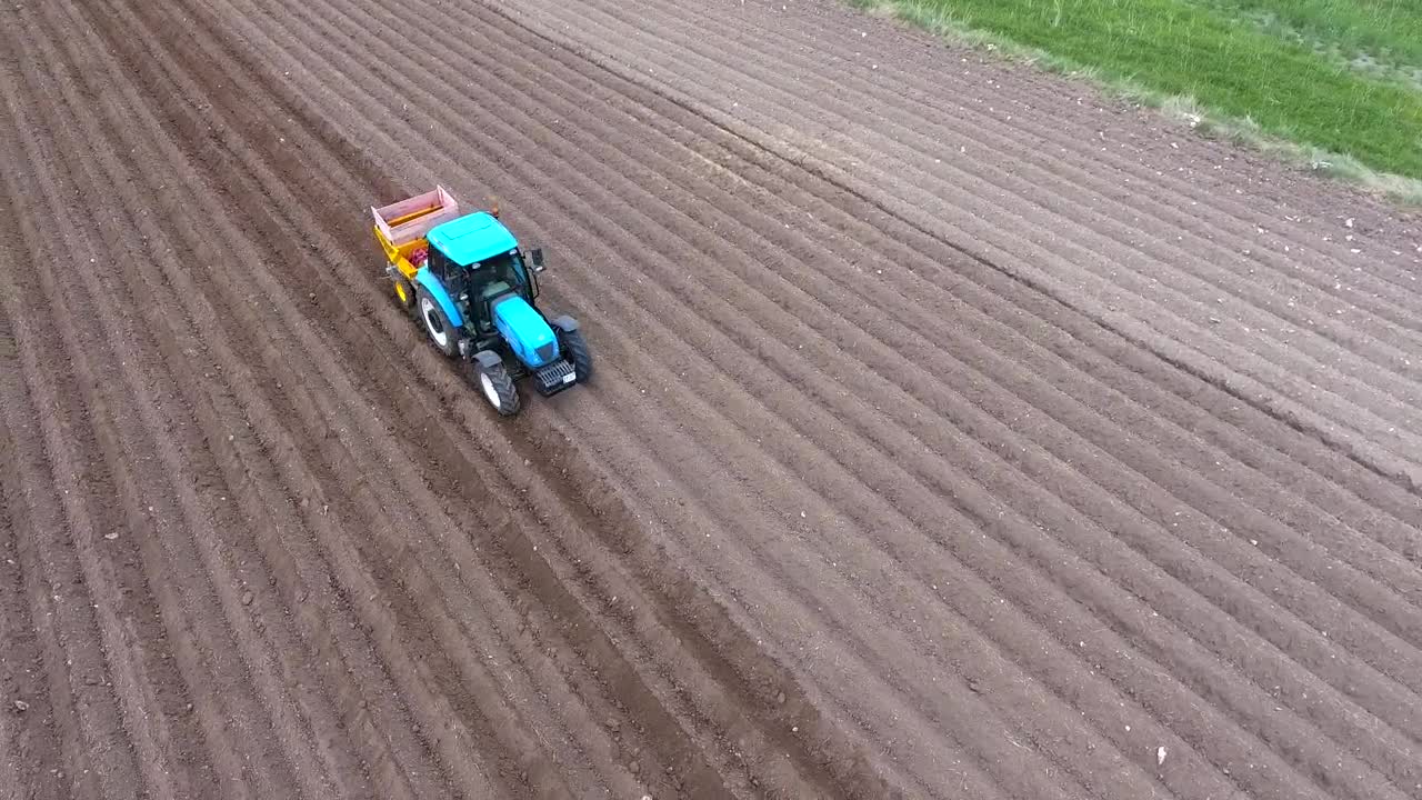 Download Stock Video A Blue Tractor Working On The Fields Live Wallpaper for PC