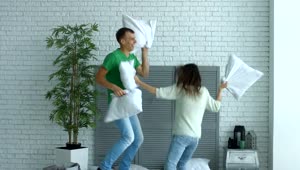Stock Video A Boy And A Girl Fighting With Pillows Live Wallpaper for PC