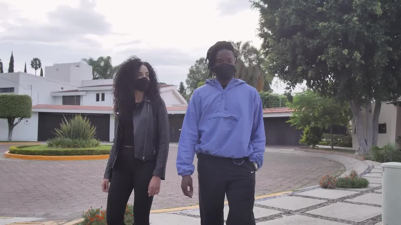 Download Stock Video A Boy And A Girl With Face Masks Walking Through Live Wallpaper for PC