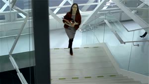 Stock Video A Businesswoman Going Upstairs In A Hurry Live Wallpaper for PC
