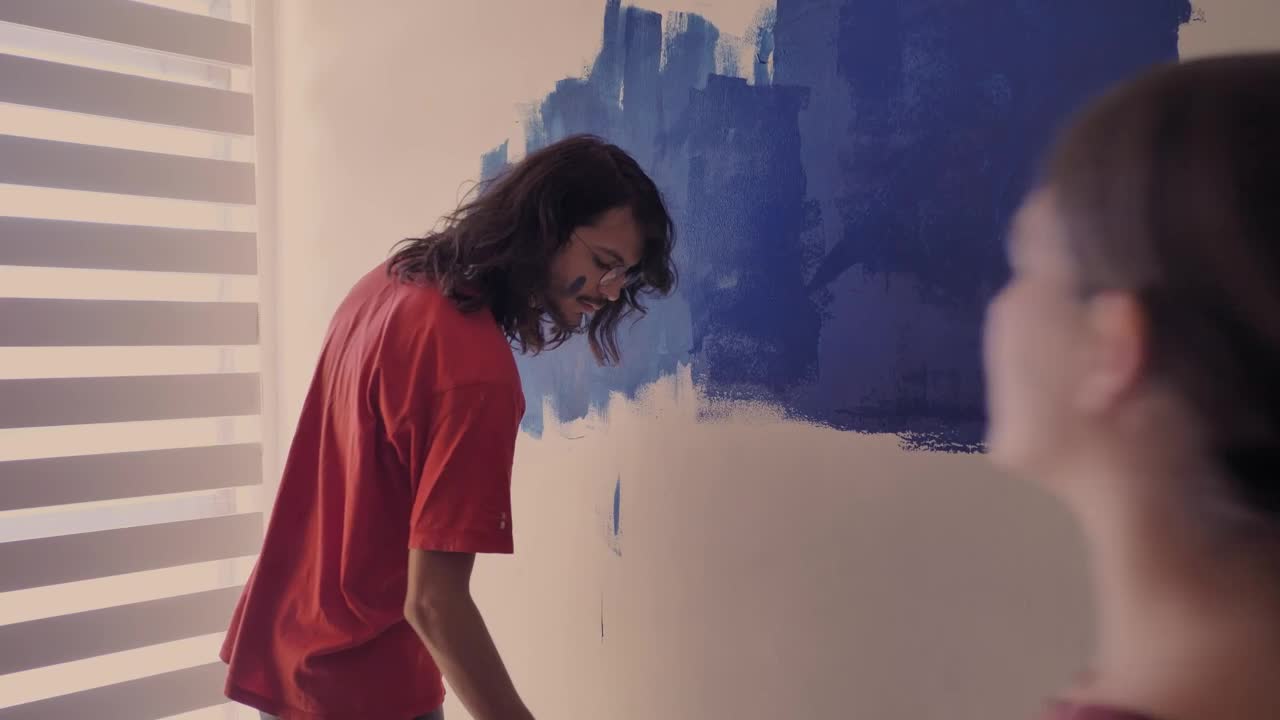 Download Stock Video A Couple In Love Painting A Wall Live Wallpaper for PC