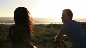 Stock Video A Couple Watching The Sunset At The Sea Live Wallpaper for PC