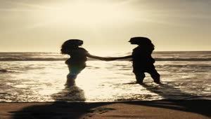 Stock Video A Couples Silhouette On The Beach At Sunset Live Wallpaper for PC